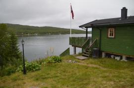 wooden cottage by the fjord