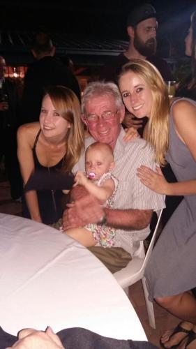 Roger with two of his five children and the youngest of his nine grandchildren